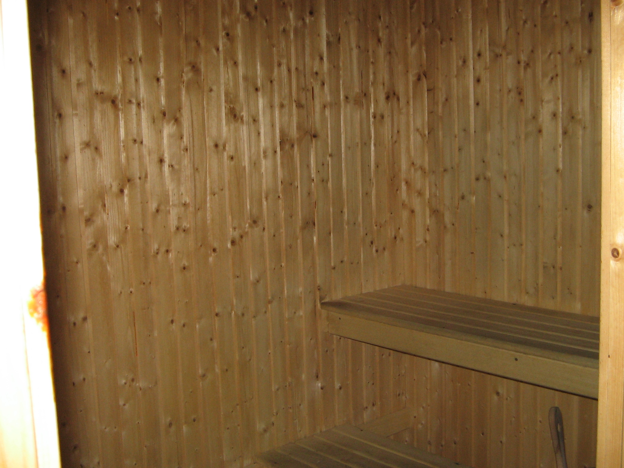Close-up of the wooden benches and paneled walls inside a sauna